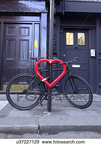 Bicycle secured to heart-shaped post View Large Photo Image Stock Photo - Bicycle secured to heart-shaped post. Fotosearch