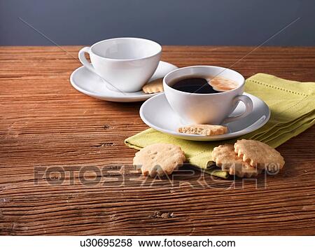 Black coffee and almond biscuits on wood table View Large Photo Image Stock Photo - Black coffee and almond biscuits on wood table. Fotosearch