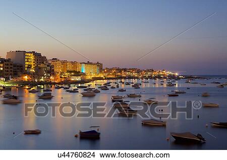 Picture - Boats on water at dusk, Qawra, Malta. Fotosearch
