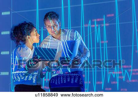Stock Photo - Business people in discussion with graphical data projection. Fotosearch