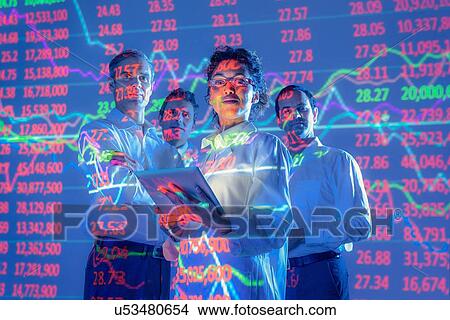 Picture - Business people with graphical projected data, portrait. Fotosearch