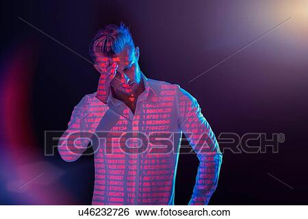 Stock Photograph - Businessman in thought with projected financial data. Fotosearch