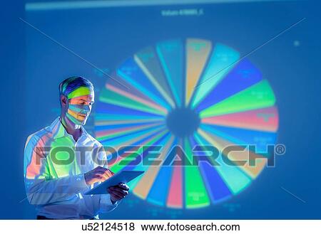 Businessman using digital tablet with projected financial data View Large Photo Image Stock Photo - Businessman using digital tablet with projected financial data. Fotosearch