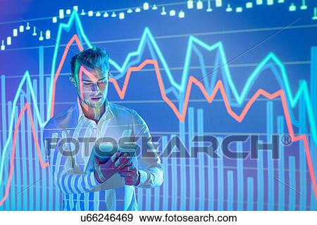 Stock Photo - Businessman using digital tablet with projected financial data. Fotosearch