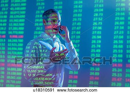 Businessman using mobile phone with projected financial data View Large Photo Image Stock Image - Businessman using mobile phone with projected financial data. Fotosearch