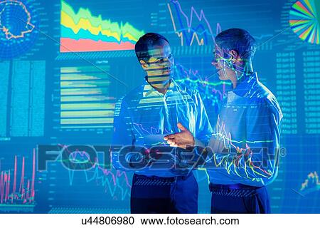 Businessmen in conversation with projected graphical financial data View Large Photo Image Stock Image - Businessmen in conversation with projected graphical financial data. Fotosearch