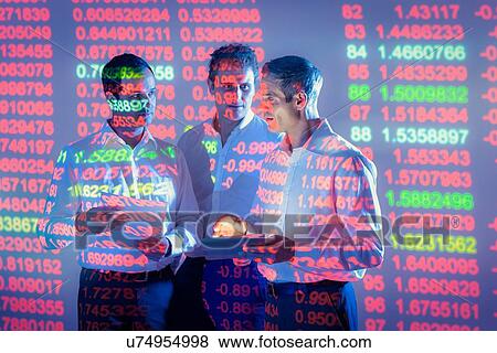 Businessmen in conversation with projected graphical financial data View Large Photo Image Stock Photo - Businessmen in conversation with projected graphical financial data. Fotosearch