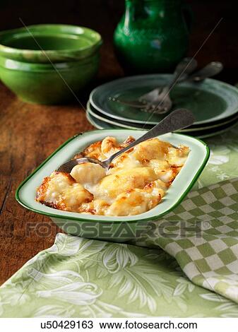 Stock Image - Cauliflower cheese in metal dish. Fotosearch