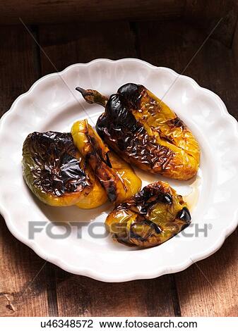 Stock Image - Char grilled green and yellow peppers in a bowl. Fotosearch