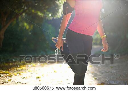 Chest down of mature woman wearing sports clothing, holding ankle stretching leg View Large Photo Image Stock Photography - Chest down of mature woman wearing sports clothing, holding ankle stretching leg. Fotosearch