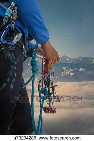 Stock Photo - Climber preparing for climb, Mont Blanc, France. Fotosearch