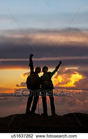 Stock Image - Climbers exulting on mountain top at sunset, Mont Blanc, France. Fotosearch