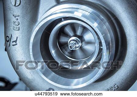 Stock Photo - Close up detail of spinning turbocharger blades in research facility. Fotosearch