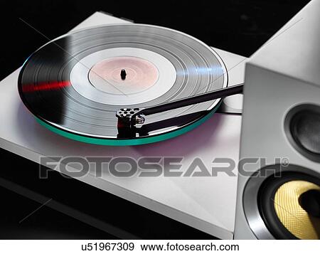 Stock Photo - Close up of hi-fi speakers with a stylus playing a record. Fotosearch