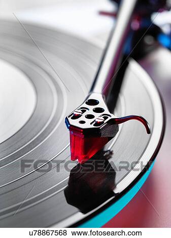 Close up of turntable stylus playing a vinyl record View Large Photo Image Stock Photo - Close up of turntable stylus playing a vinyl record. Fotosearch