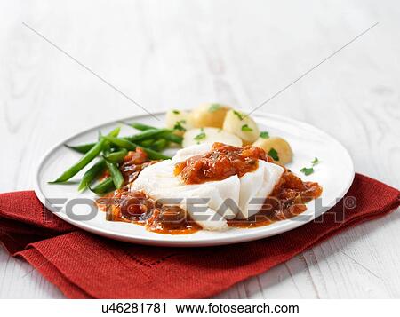Stock Image - Cod fillet in tomato sauce with green beans and new potatoes. Fotosearch