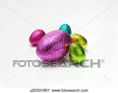Colourful easter eggs in shiny foil on white background View Large Photo Image Stock Photo - Colourful easter eggs in shiny foil on white background. Fotosearch