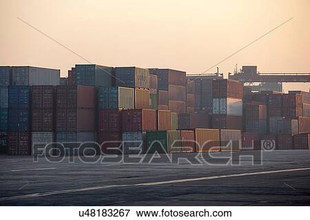 Stock Photo - Containers at port during sunrise. Fotosearch