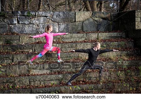 Couple on stone steps in lunge stance arms open stretching, looking away View Large Photo Image Stock Image - Couple on stone steps in lunge stance arms open stretching, looking away. Fotosearch