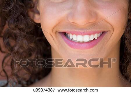 Stock Photo - Cropped close up of smiling girl. Fotosearch