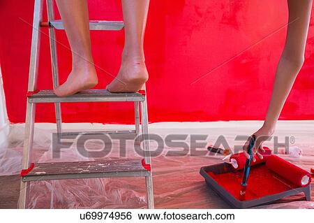 Cropped shot of girl and mother painting wall red View Large Photo Image Stock Photograph - Cropped shot of girl and mother painting wall red. Fotosearch