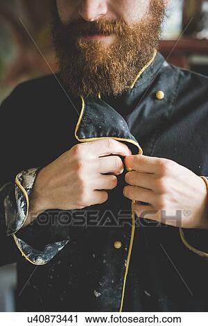 Cropped view of bearded mid adult man buttoning up clay covered jacket View Large Photo Image Stock Image - Cropped view of bearded mid adult man buttoning up clay covered jacket. Fotosearch