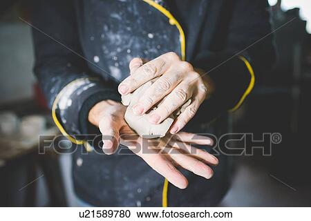 Cropped view of mid adult man squeezing clay in hands View Large Photo Image Stock Image - Cropped view of mid adult man squeezing clay in hands. Fotosearch
