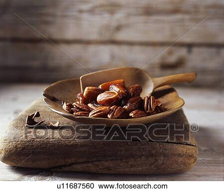 Dates and walnuts in rustic wooden bowl with wooden scoop View Large Photo Image Stock Image - Dates and walnuts in rustic wooden bowl with wooden scoop. Fotosearch