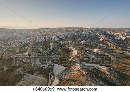 Distant view of hot air balloons over landscape, Cappadocia, Anatolia, Turkey View Large Photo Image Stock Photo - Distant view of hot air balloons over landscape, Cappadocia, Anatolia, Turkey. Fotosearch