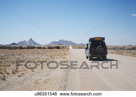 Stock Photograph - Driving towards Spitzkoppe mountain, Namibia. Fotosearch