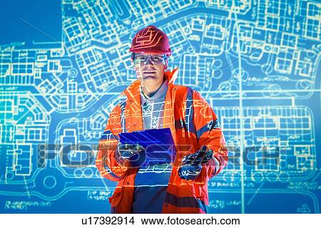 Picture - Engineer with digital tablet and projected plans, portrait. Fotosearch