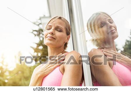 Exhausted mature female runner leaning against patio door View Large Photo Image Stock Photography - Exhausted mature female runner leaning against patio door. Fotosearch