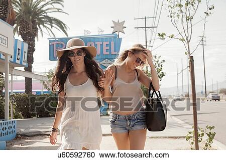 Female friends walking past motel, Los Angeles, California, USA View Large Photo Image Stock Image - Female friends walking past motel, Los Angeles, California, USA. Fotosearch