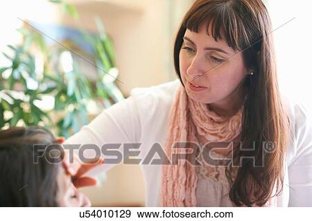 Female make up artist applying foundation to clients forehead View Large Photo Image Stock Photo - Female make up artist applying foundation to clients forehead. Fotosearch