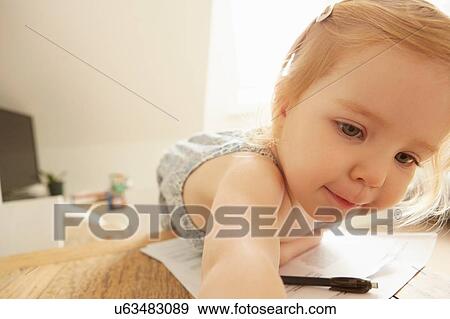 Female toddler reaching across table whilst drawing View Large Photo Image Stock Photo - Female toddler reaching across table whilst drawing. Fotosearch