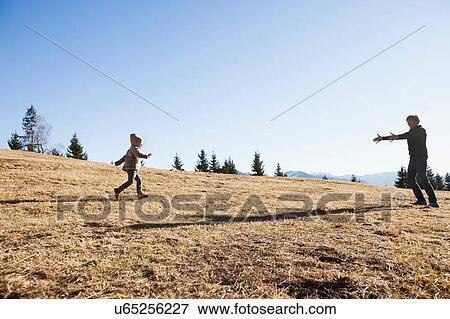 Female toddler running to father on hill, Tegernsee, Bavaria, Germany View Large Photo Image Stock Photo - Female toddler running to father on hill, Tegernsee, Bavaria, Germany. Fotosearch