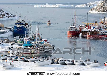 Stock Photo - Fishing boat arriving at harbour, Disko Bay, Ilulissat, Greenland. Fotosearch