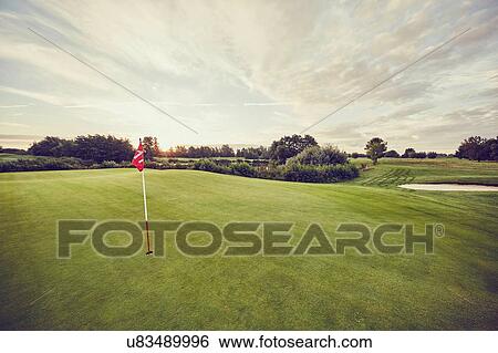 Stock Photograph - Flag in hole on golf course, Korschenbroich, Dusseldorf, Germany. Fotosearch