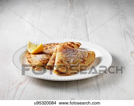 Picture - Folded pancakes with sugar and lemon. Fotosearch