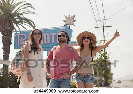 Friends hitchhiking, Los Angeles, California, USA View Large Photo Image Stock Photo - Friends hitchhiking, Los Angeles, California, USA. Fotosearch