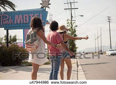 Stock Photograph - Friends hitchhiking, Los Angeles, California, USA. Fotosearch