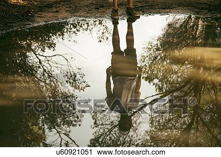 Full length reflection of young man in puddle, Costa Smeralda, Sardinia, Italy View Large Photo Image Stock Image - Full length reflection of young man in puddle, Costa Smeralda, Sardinia, Italy. Fotosearch