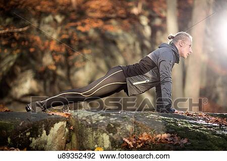 Full length side view of mid adult man on rocks doing press up View Large Photo Image Stock Image - Full length side view of mid adult man on rocks doing press up. Fotosearch