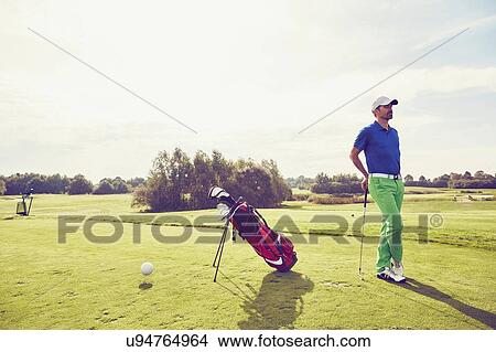 Picture - Golfer beside golf bag on course, Korschenbroich, Dusseldorf, Germany. Fotosearch