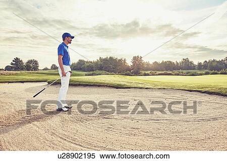 Golfer in sand trap, Korschenbroich, Dusseldorf, Germany View Large Photo Image Stock Photography - Golfer in sand trap, Korschenbroich, Dusseldorf, Germany. Fotosearch