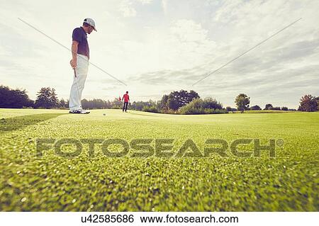 Stock Photograph - Golfer on course, Korschenbroich, Dusseldorf, Germany. Fotosearch