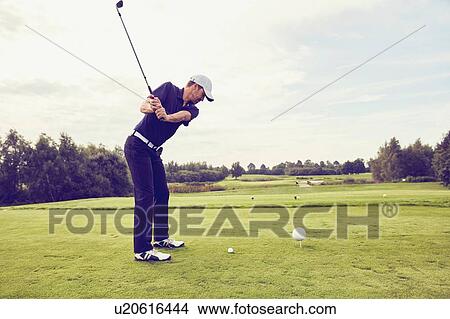 Picture - Golfer playing golf on course, Korschenbroich, Dusseldorf, Germany. Fotosearch
