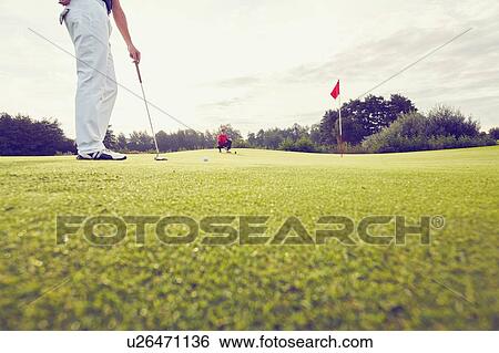 Golfer playing near hole, Korschenbroich, Dusseldorf, Germany View Large Photo Image Stock Photograph - Golfer playing near hole, Korschenbroich, Dusseldorf, Germany. Fotosearch