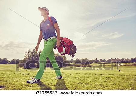 Golfer walking on course, Korschenbroich, Dusseldorf, Germany View Large Photo Image Stock Image - Golfer walking on course, Korschenbroich, Dusseldorf, Germany. Fotosearch