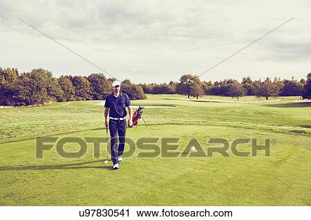 Stock Image - Golfer walking on course, Korschenbroich, Dusseldorf, Germany. Fotosearch